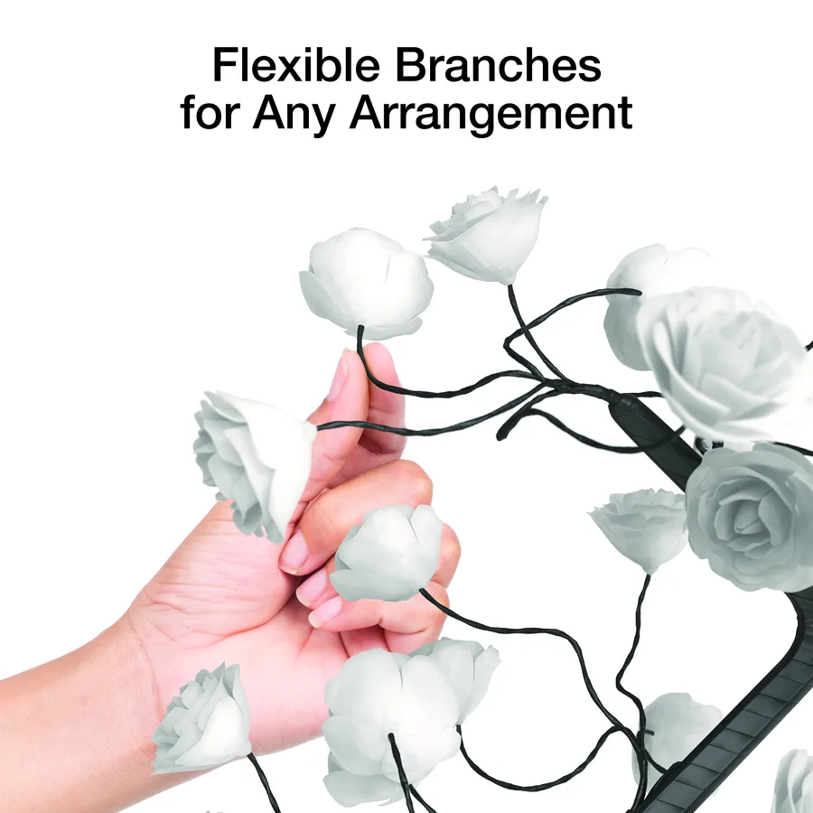 Hand adjusting the flexible branches of the Atmospheres Rose Tree lamp